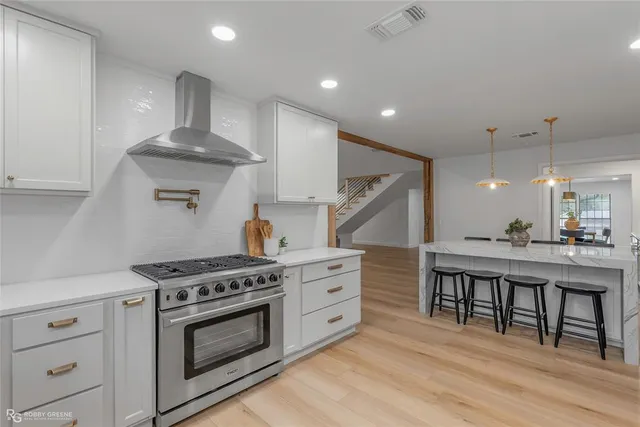 a kitchen with a stove and a wooden floors