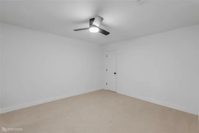 an empty room with a empty space and a ceiling fan