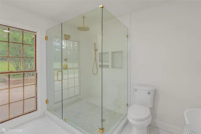 a bathroom with a shower toilet and sink