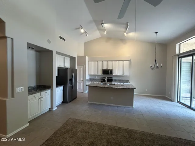 a large kitchen with a large counter top appliances and cabinets