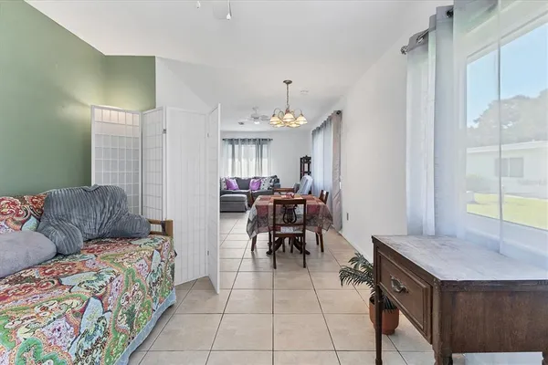 a living room with furniture and a dining table