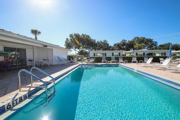 a view of a swimming pool with lounge chair