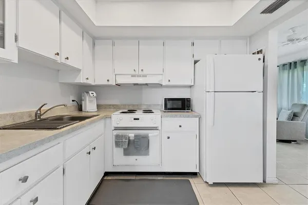 a kitchen with cabinets and appliances