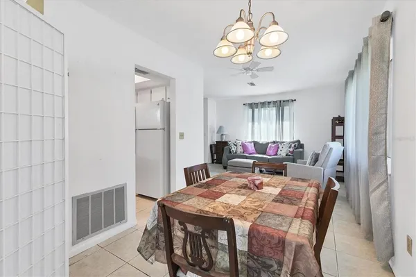 a view of a dining room with furniture a chandelier and wooden floor