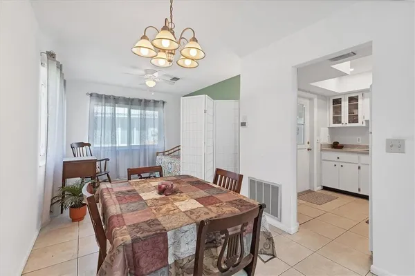 a view of a dining room with furniture and chandelier