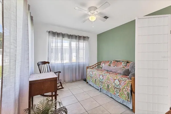 a bedroom with a bed and a chair