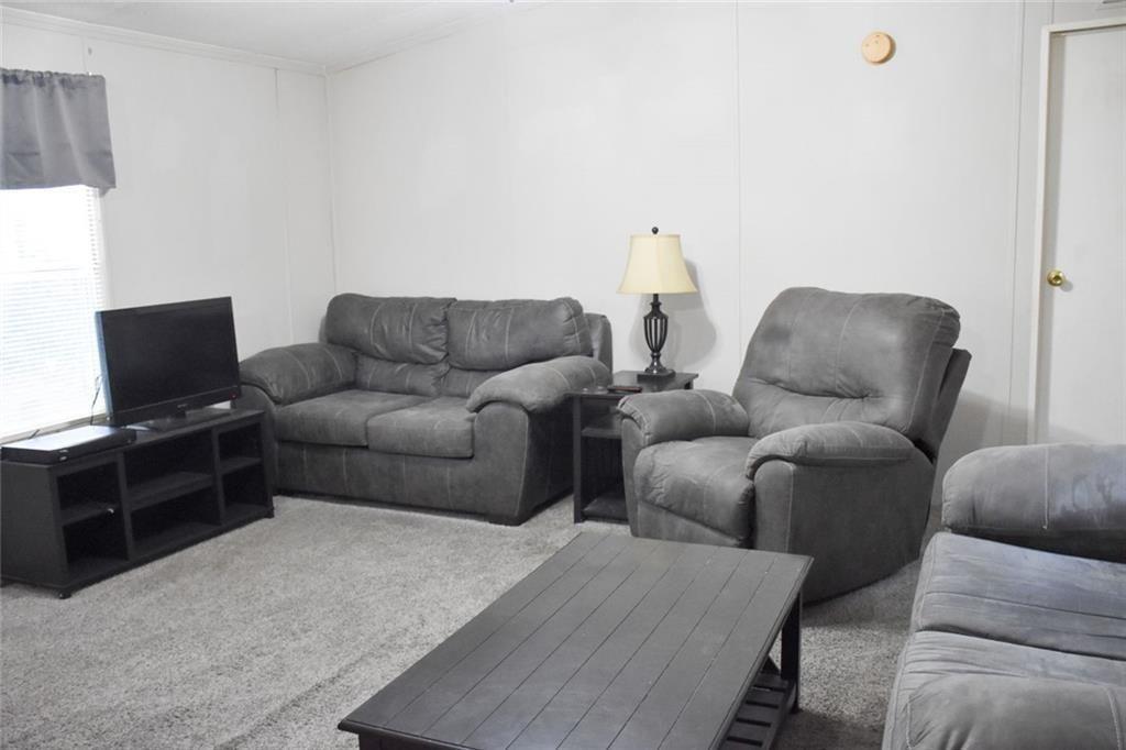 13396 Highway 53 Fairmount, GA 30139 - Photo 12 of 20 a living room with furniture and a flat screen tv