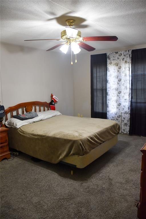 13396 Highway 53 Fairmount, GA 30139 - Photo 17 of 20 a bedroom with a bed and a chandelier