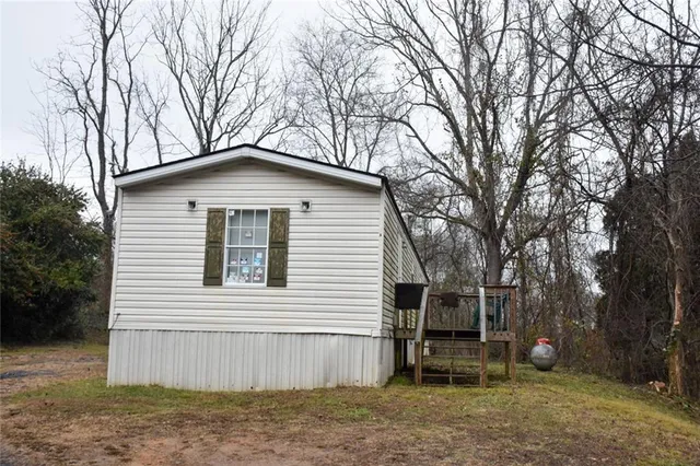a white house that has a tree in front of it