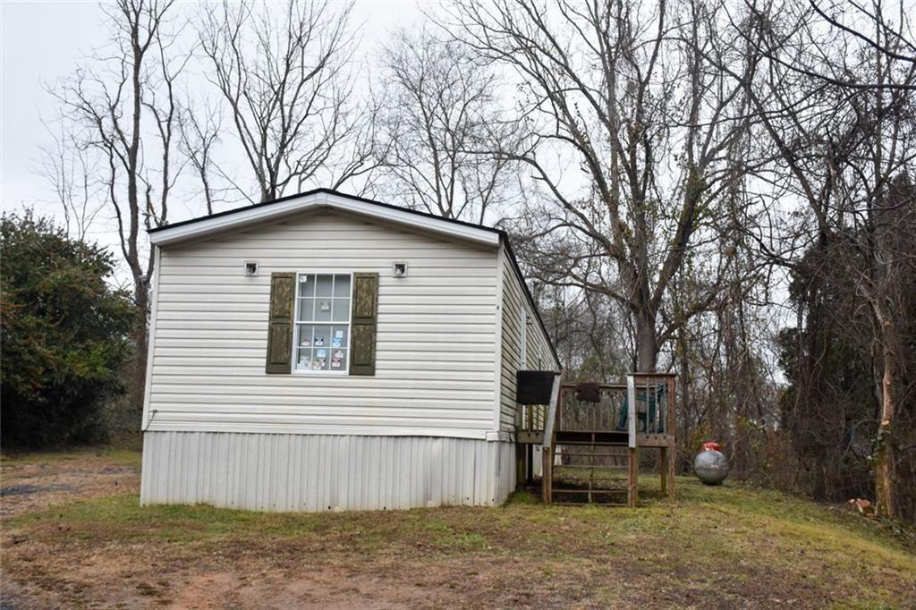 13396 Highway 53 Fairmount, GA 30139 - Photo 3 of 20 a white house that has a tree in front of it