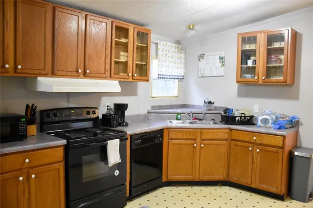a kitchen with stainless steel appliances a stove a sink and a microwave