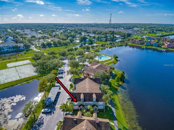 an aerial view of a house with outdoor space and lake view