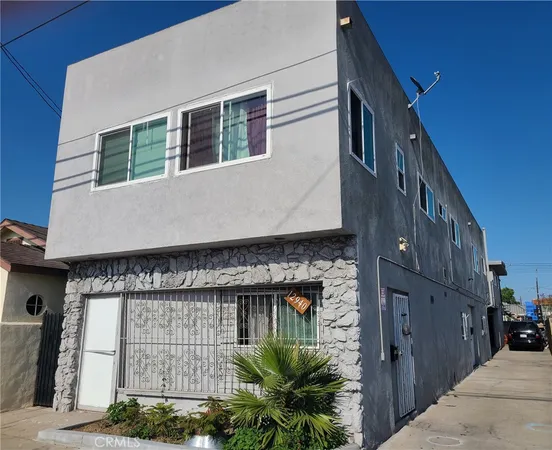 a front view of a house with plants