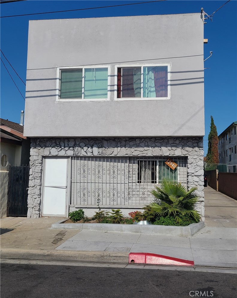 12940 Prairie Avenue Hawthorne, CA 90250 - Photo 2 of 17 a front view of a house with a yard and garage
