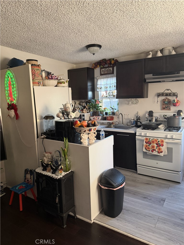 12940 Prairie Avenue Hawthorne, CA 90250 - Photo 8 of 17 a kitchen with a sink and a stove top oven