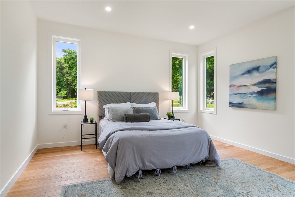 23 Deerhaven Road Lincoln, MA 01773 - Photo 17 of 39 a bedroom with a bed and a painting on the wall