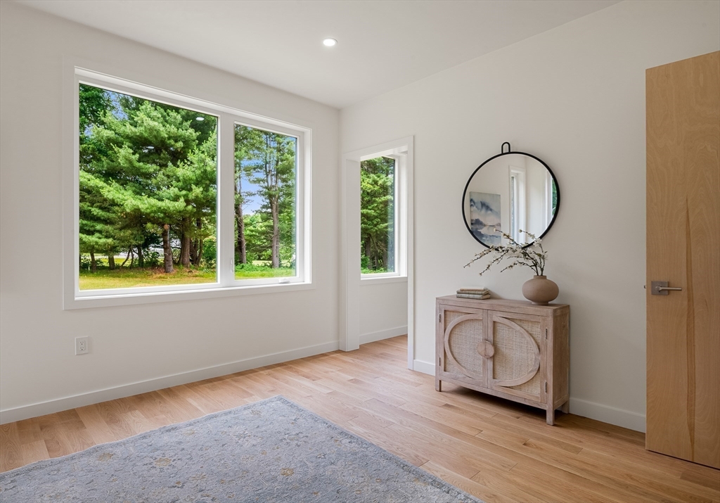 23 Deerhaven Road Lincoln, MA 01773 - Photo 18 of 39 a room with wooden floor a glass door and a window