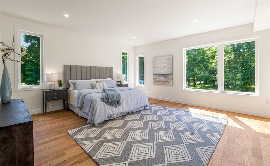 23 Deerhaven Road Lincoln, MA 01773 - Photo 23 of 39 a bed sitting in a bedroom next to a window