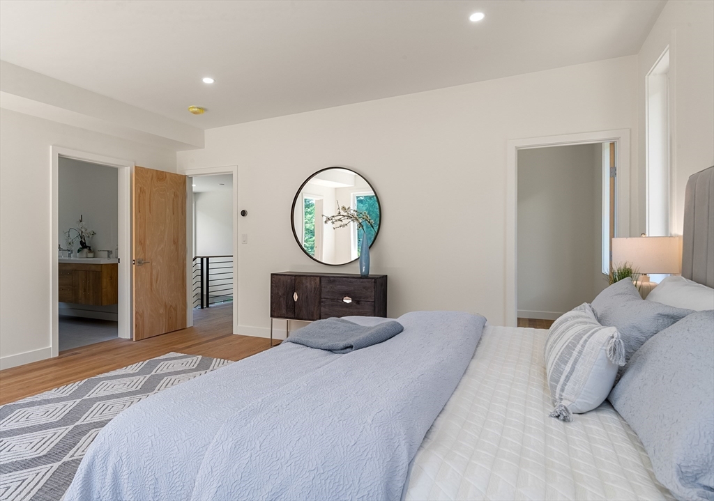 23 Deerhaven Road Lincoln, MA 01773 - Photo 24 of 39 a bedroom with a bed and a large mirror