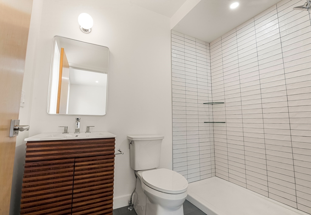 23 Deerhaven Road Lincoln, MA 01773 - Photo 31 of 39 a bathroom with a toilet sink vanity and mirror
