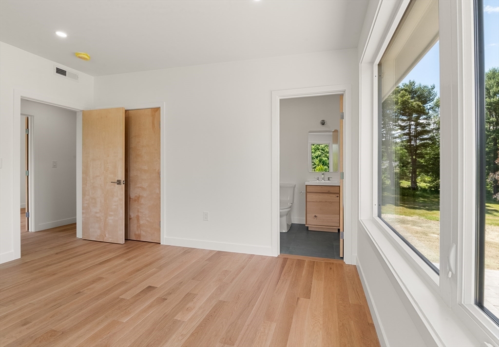 23 Deerhaven Road Lincoln, MA 01773 - Photo 32 of 39 wooden floor in an empty room with a window
