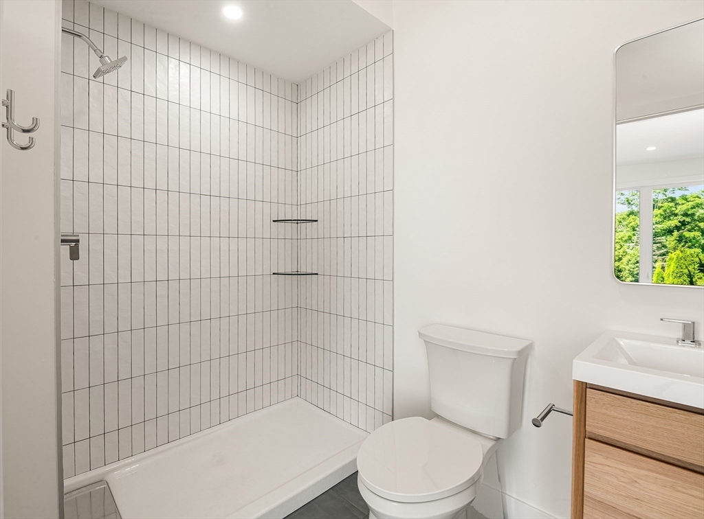 23 Deerhaven Road Lincoln, MA 01773 - Photo 33 of 39 a white toilet sitting next to a shower curtain