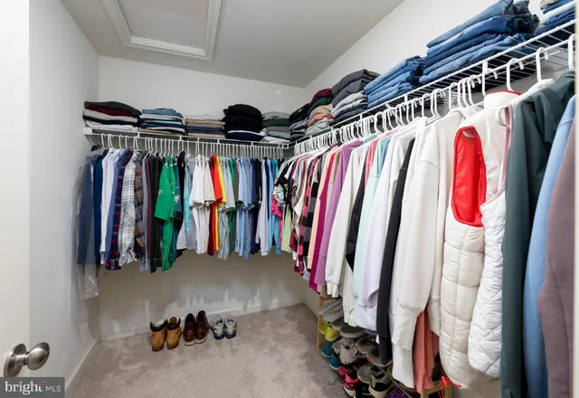 a bedroom with bed and a large window