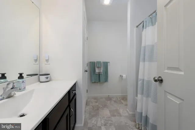 a room with a baby bed baby crib and dresser