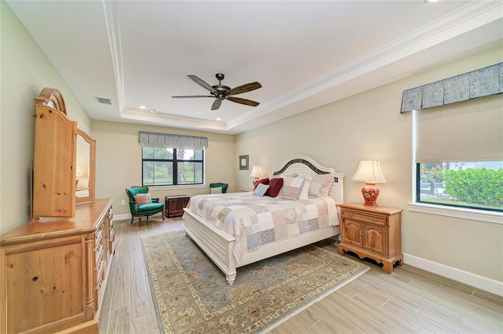 16341 Hidden Oak Loop Lakewood Ranch, FL 34211 - Photo 24 of 76 a bed room with a bed and a large window