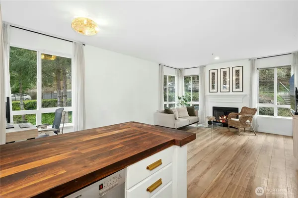 a living room with fireplace furniture and a large window