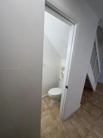 a white toilet sitting next to a small bathroom