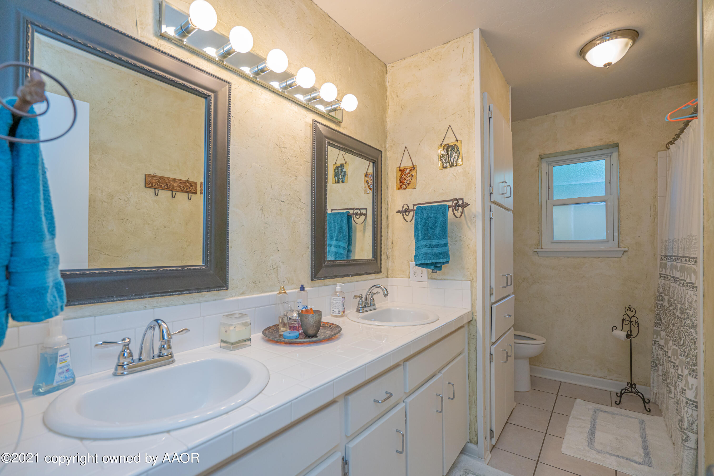 5308 Hillside Road Amarillo, TX 79109 - Photo 18 of 23 a bathroom with a double vanity sink mirror and toilet