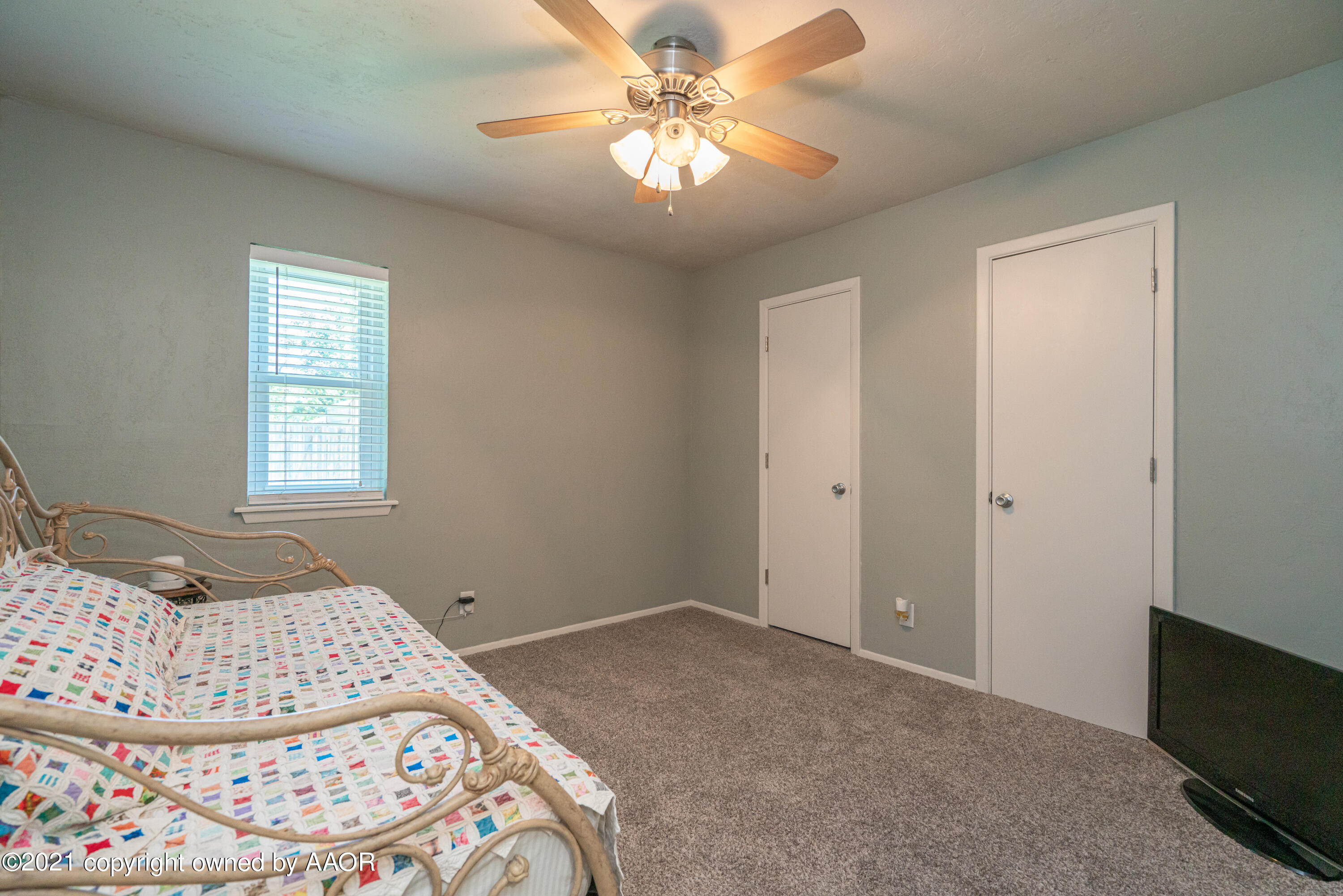 5308 Hillside Road Amarillo, TX 79109 - Photo 19 of 23 a bedroom with a bed and a chandelier