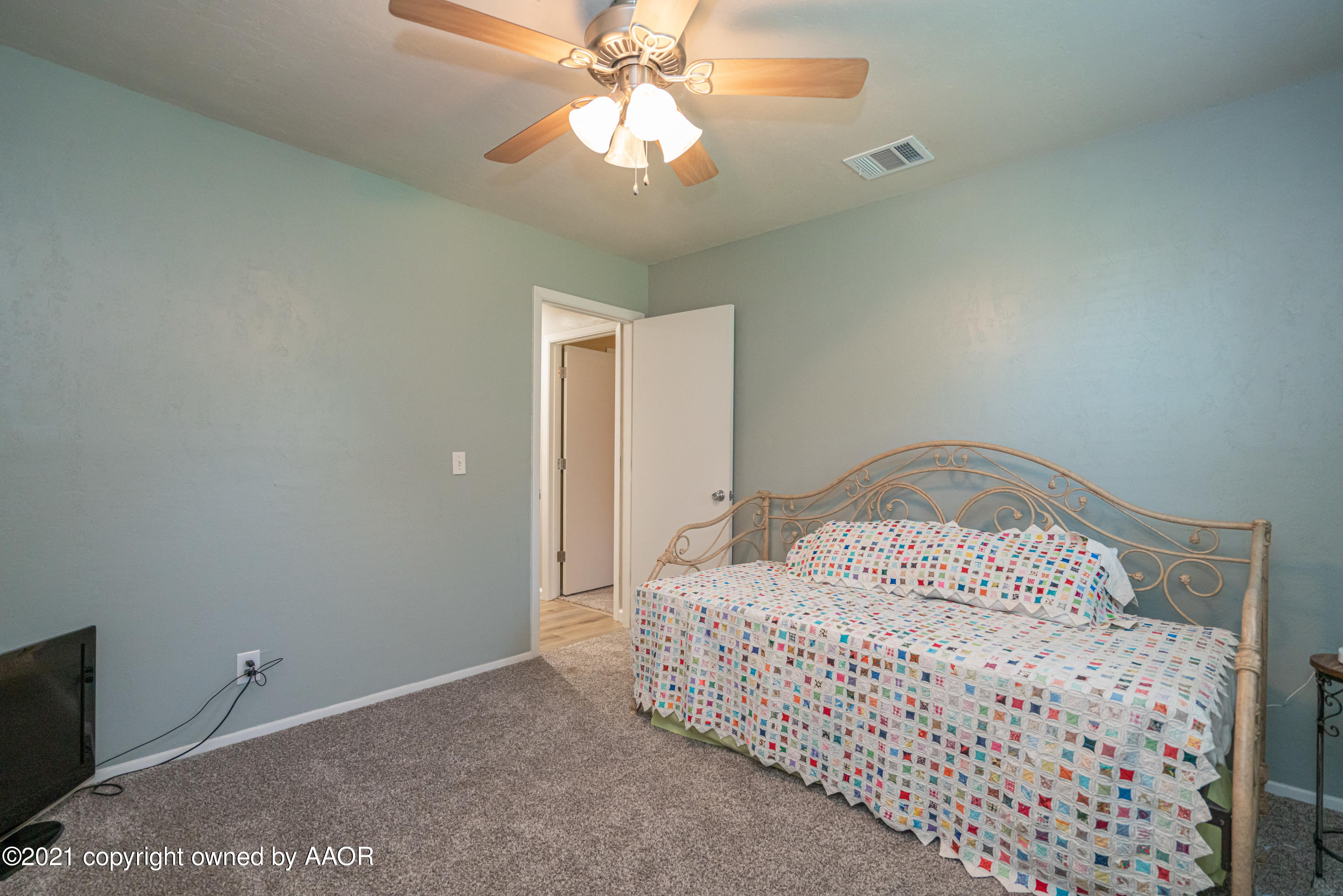 5308 Hillside Road Amarillo, TX 79109 - Photo 20 of 23 a bedroom with a bed and a chandelier