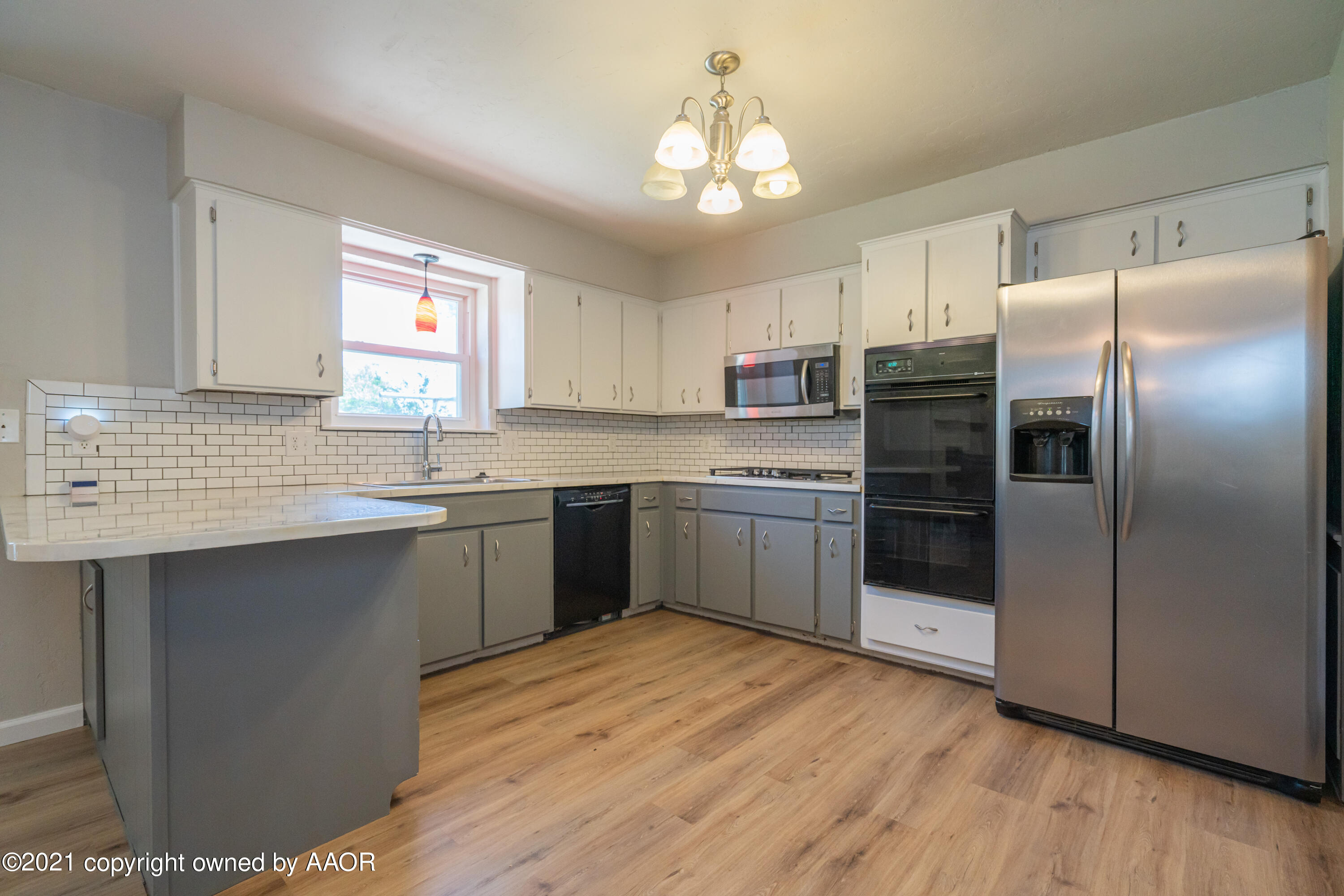 5308 Hillside Road Amarillo, TX 79109 - Photo 7 of 23 a kitchen with stainless steel appliances a refrigerator sink and cabinets