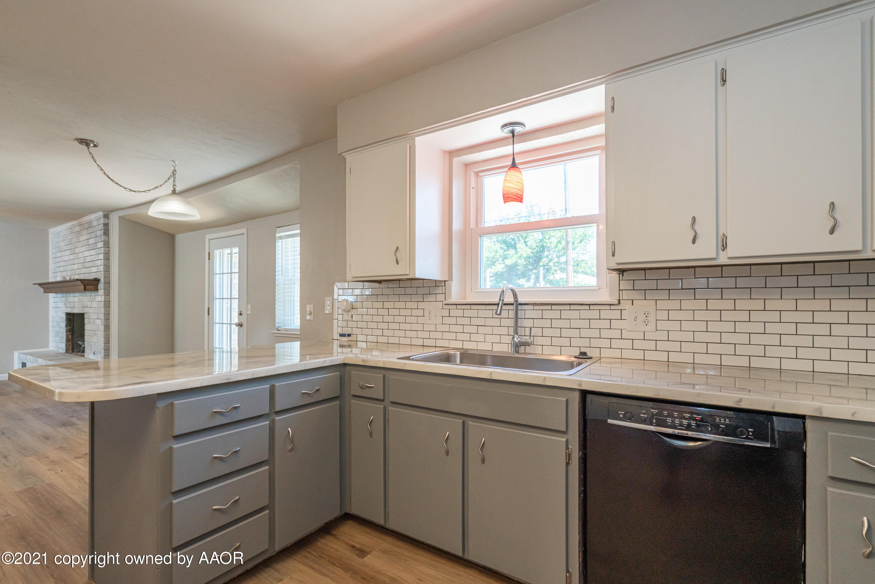 5308 Hillside Road Amarillo, TX 79109 - Photo 8 of 23 a kitchen with a sink stove and cabinets