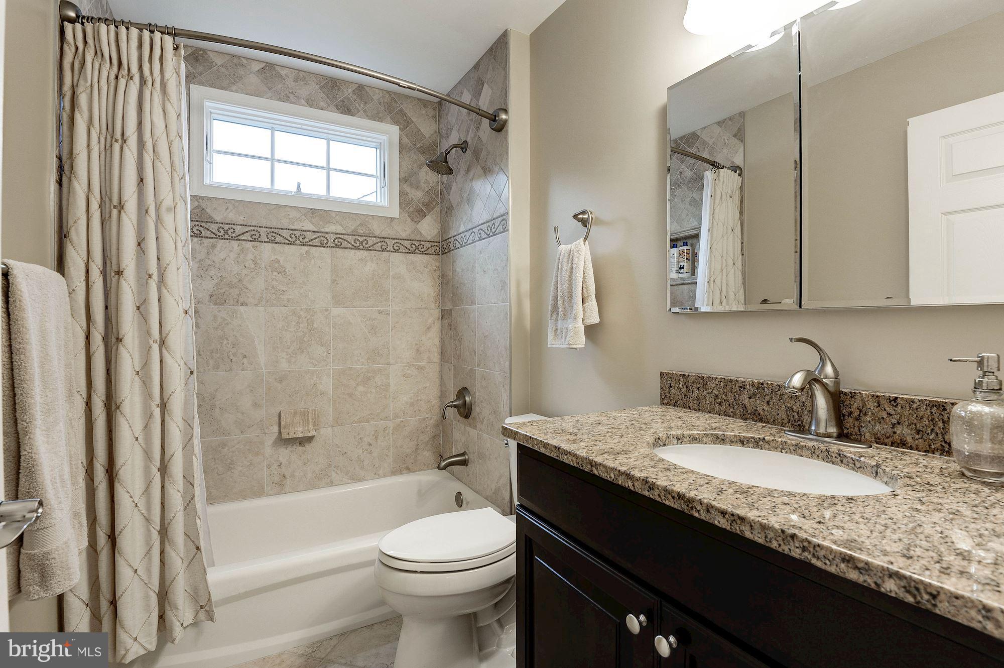 1328 Murray Downs Way Reston, VA 20194 - Photo 22 of 30 a bathroom with a granite countertop sink toilet and shower
