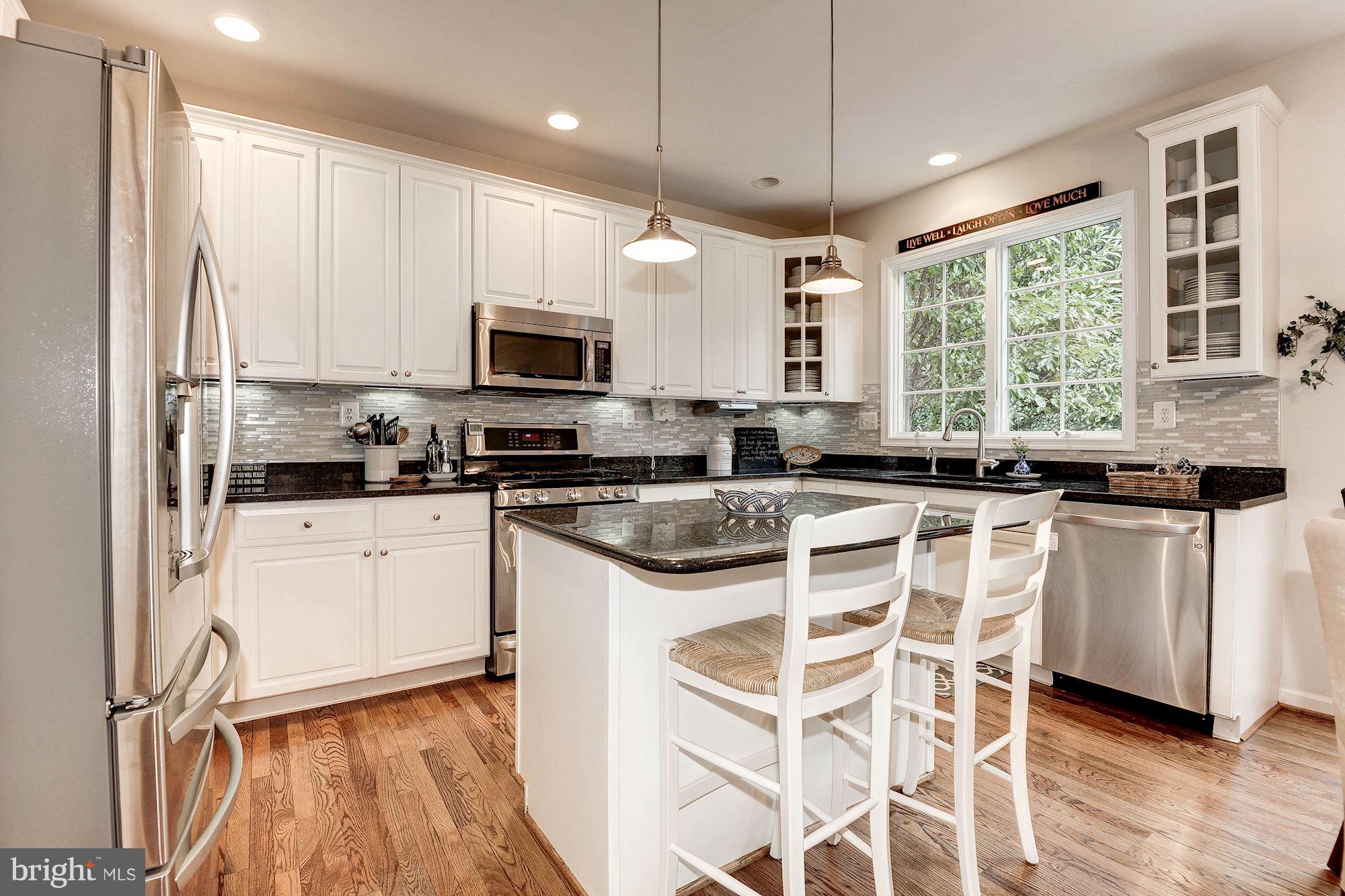 1328 Murray Downs Way Reston, VA 20194 - Photo 4 of 30 a kitchen with stainless steel appliances granite countertop a stove a sink and a microwave