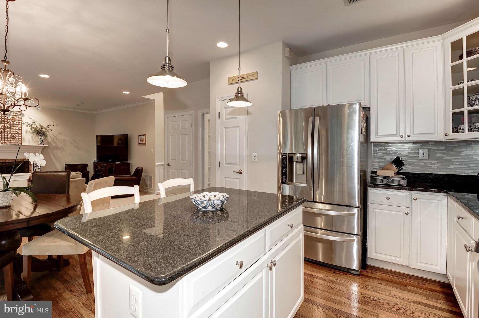 1328 Murray Downs Way Reston, VA 20194 - Photo 10 of 30 a kitchen with stainless steel appliances granite countertop a sink a stove and a refrigerator