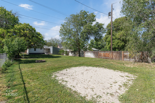146 West 200 N Street Springville, UT 84663 - Photo 26 of 29 Expansive backyard with a large sand area, mature trees, and a fire pit