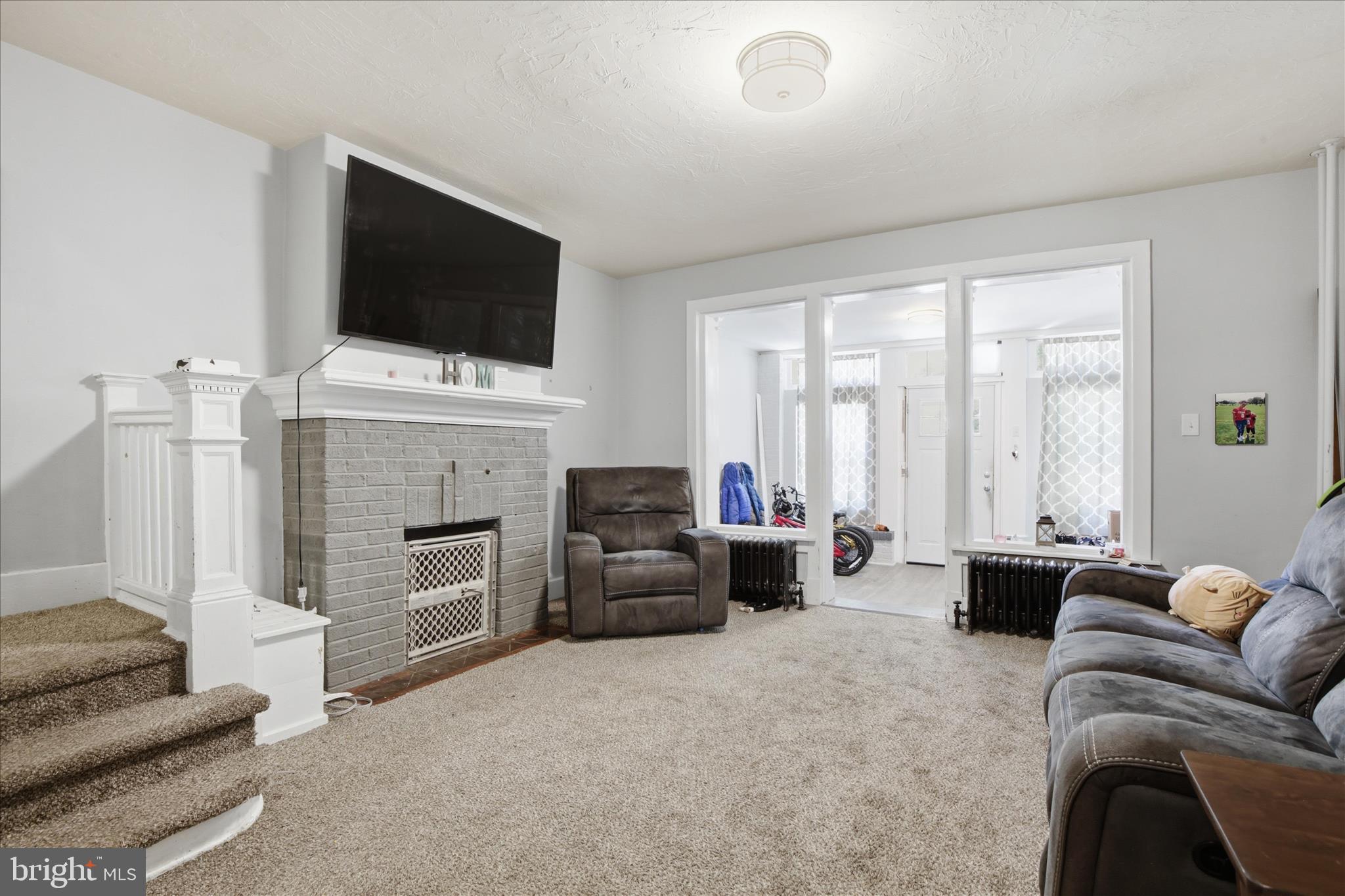 254 South 8th Street Lebanon, PA 17042 - Photo 6 of 25 a living room with furniture a flat screen tv and a fireplace
