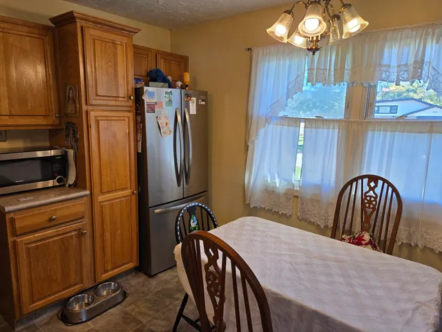 a view of a kitchen with dining room and wooden floor