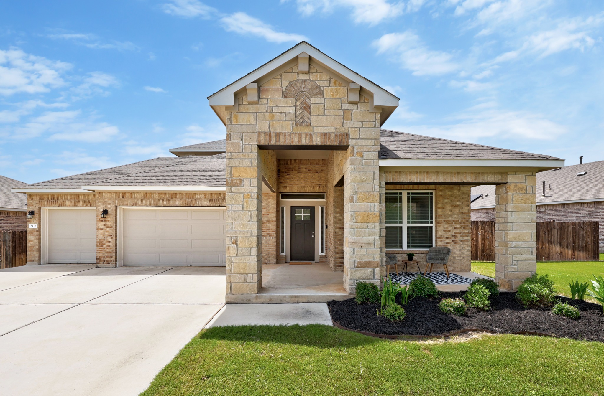 2413 Starhill Ranch Street Georgetown, TX 78628 - Photo 1 of 40 a front view of a house with garden