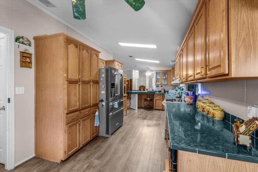 1849 Floyd Road Weatherford, TX 76087 - Photo 15 of 40 a kitchen with stainless steel appliances granite countertop a refrigerator a stove and a wooden floors