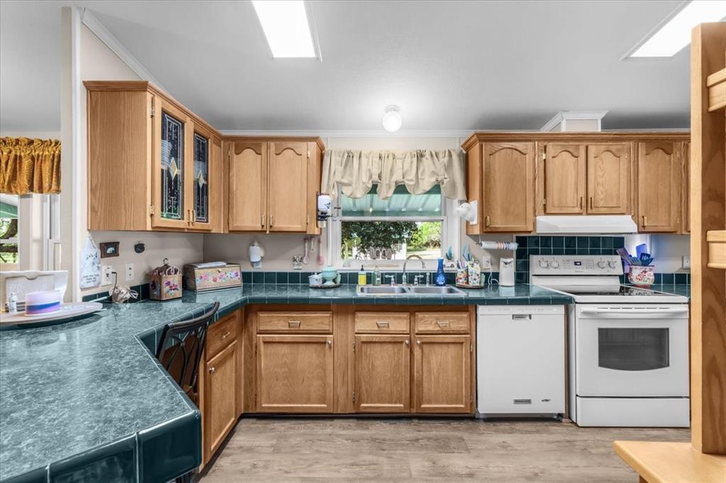1849 Floyd Road Weatherford, TX 76087 - Photo 16 of 40 a kitchen with a sink stove and cabinets