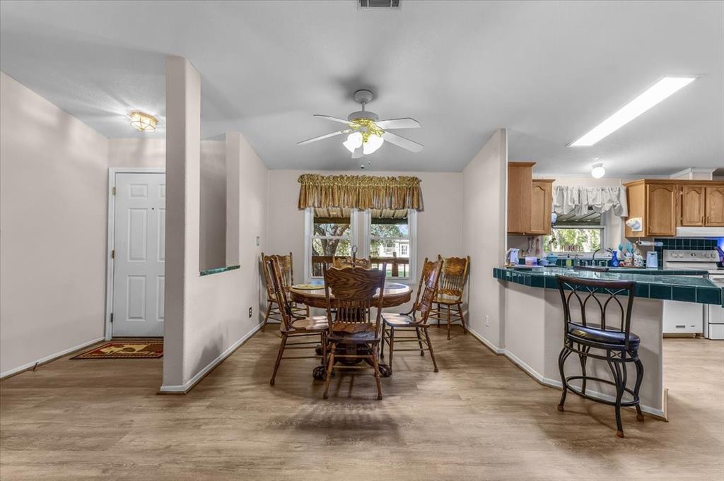 1849 Floyd Road Weatherford, TX 76087 - Photo 20 of 40 a view of a dining room with furniture window and wooden floor