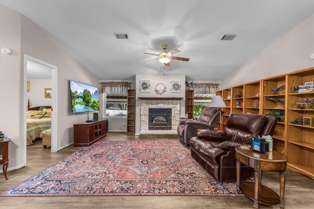 1849 Floyd Road Weatherford, TX 76087 - Photo 21 of 40 a living room with furniture a rug and a fireplace