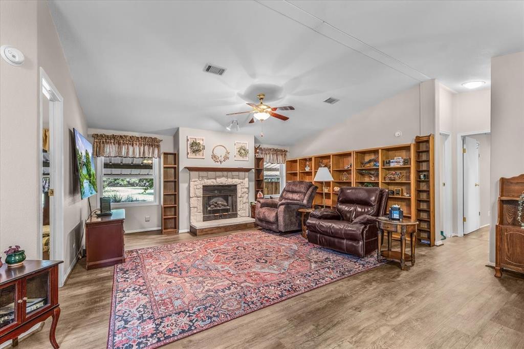 1849 Floyd Road Weatherford, TX 76087 - Photo 22 of 40 a living room with furniture large window and a fireplace