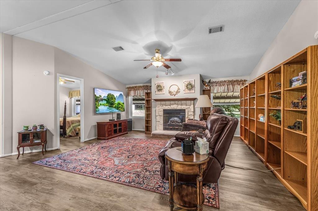 1849 Floyd Road Weatherford, TX 76087 - Photo 23 of 40 a living room with furniture a fireplace and a table