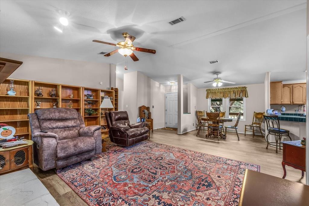 1849 Floyd Road Weatherford, TX 76087 - Photo 24 of 40 a living room with furniture a chandelier and a rug